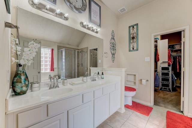 full bathroom featuring double vanity, a shower stall, a sink, and tile patterned floors