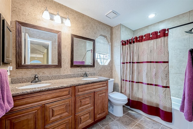 bathroom with a sink, toilet, double vanity, and shower / tub combo with curtain