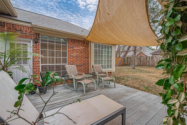 view of patio with a deck and fence