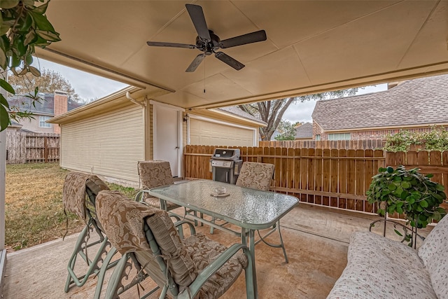 view of patio / terrace with grilling area, outdoor dining space, a ceiling fan, and fence