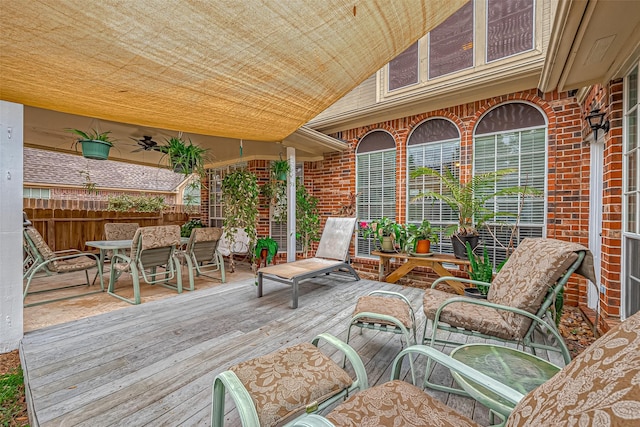 wooden terrace featuring outdoor dining space and fence