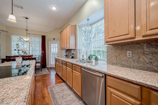 kitchen with wood finished floors, visible vents, a sink, pendant lighting, and stainless steel dishwasher