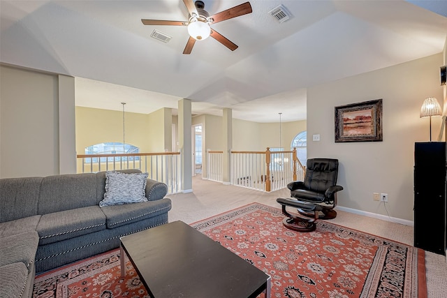 living room with visible vents, baseboards, and carpet flooring