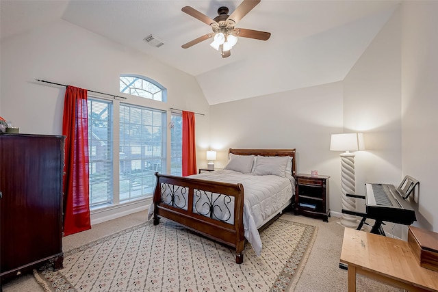 bedroom with vaulted ceiling, baseboards, visible vents, and light carpet