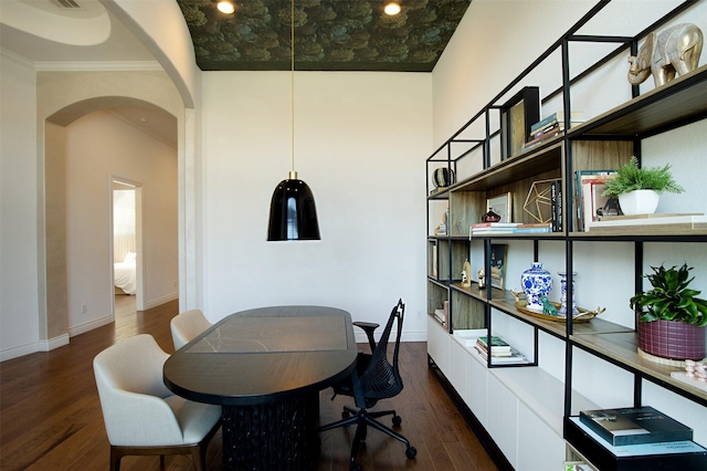 home office with baseboards, arched walkways, dark wood finished floors, and ornamental molding