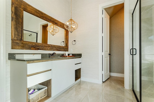 full bath featuring a stall shower, vanity, and baseboards