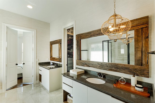 bathroom featuring a chandelier, recessed lighting, and vanity