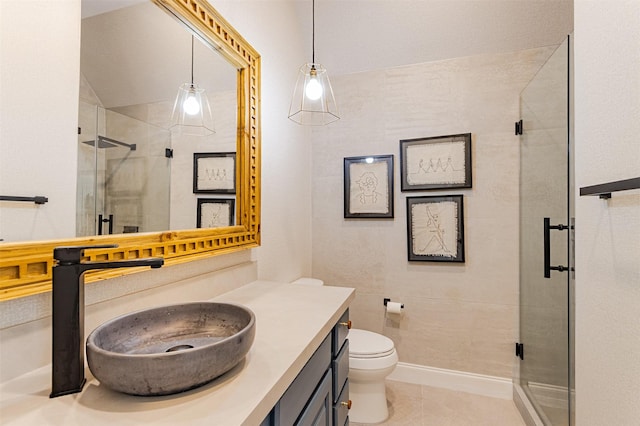 bathroom featuring a shower stall, baseboards, toilet, tile patterned floors, and vanity