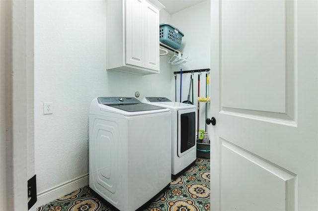 washroom with tile patterned floors, baseboards, cabinet space, and separate washer and dryer