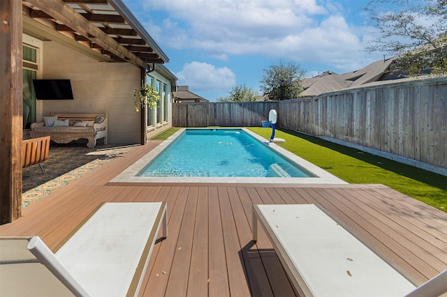 view of pool with a fenced in pool, a wooden deck, and a fenced backyard