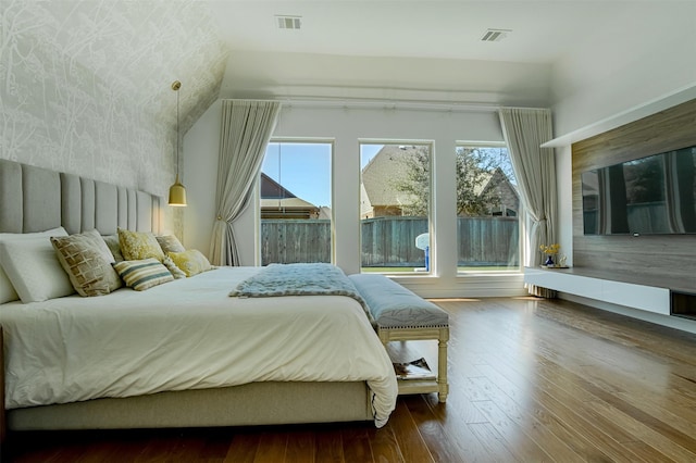 bedroom with visible vents and wood finished floors