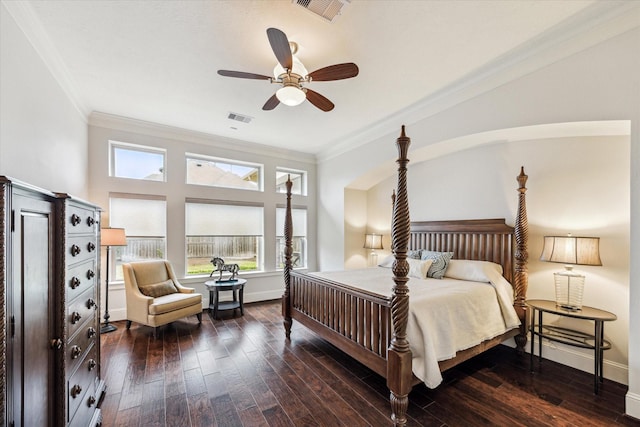 bedroom with dark wood-style floors, visible vents, and multiple windows