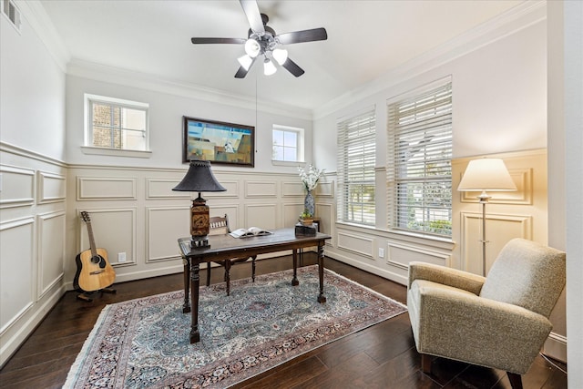 office area with visible vents, dark wood finished floors, a ceiling fan, ornamental molding, and a decorative wall