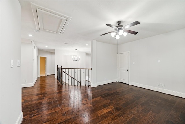 spare room featuring recessed lighting, wood-type flooring, and baseboards