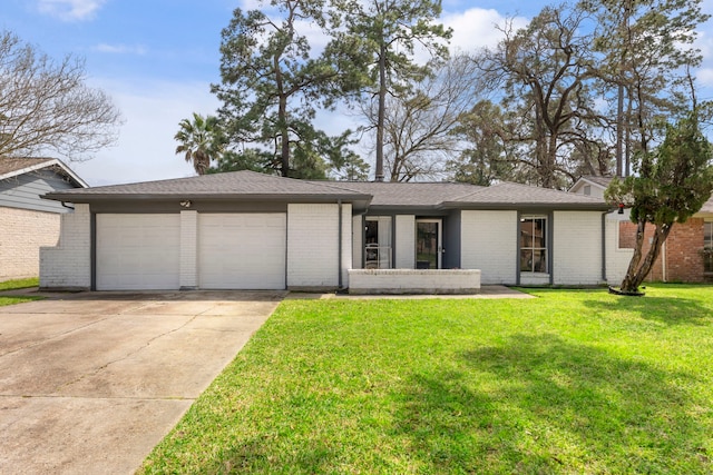 view of front facade featuring driveway, a front lawn, an attached garage, and brick siding