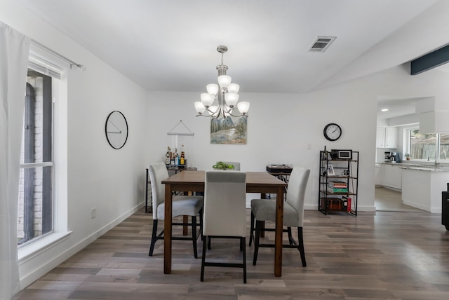 dining space with a healthy amount of sunlight, visible vents, and wood finished floors