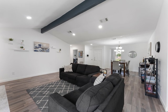 living area featuring lofted ceiling with beams, baseboards, visible vents, and wood finished floors