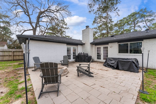 view of patio / terrace with fence, grilling area, and french doors