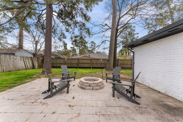 view of patio / terrace featuring an outdoor fire pit and a fenced backyard