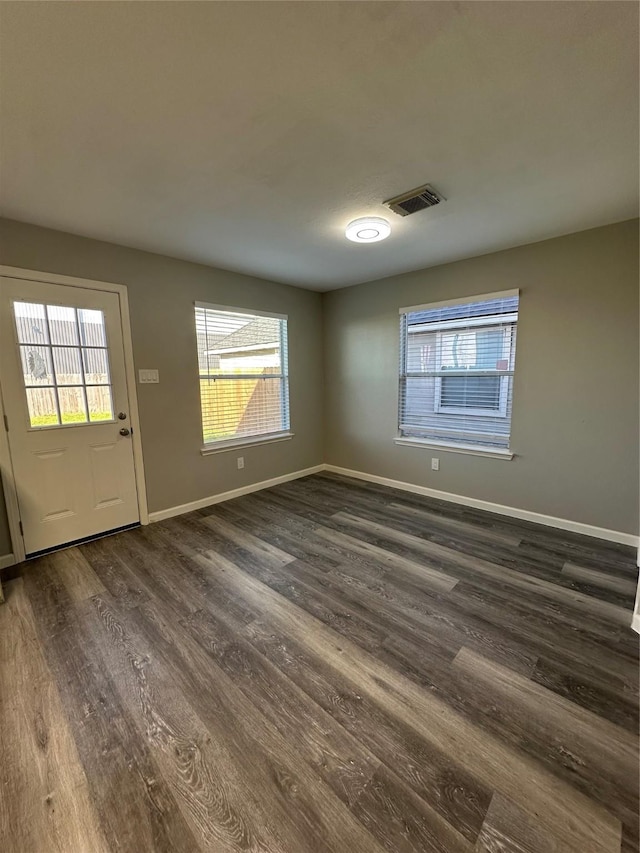 entrance foyer with dark wood-style flooring, visible vents, and baseboards