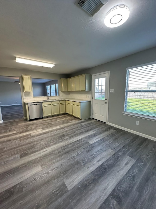 kitchen with light countertops, a sink, visible vents, and stainless steel dishwasher