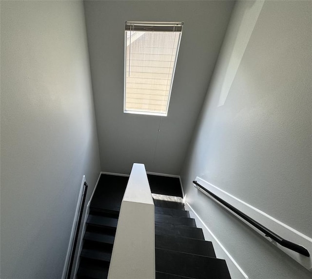 stairs with baseboards and wood finished floors