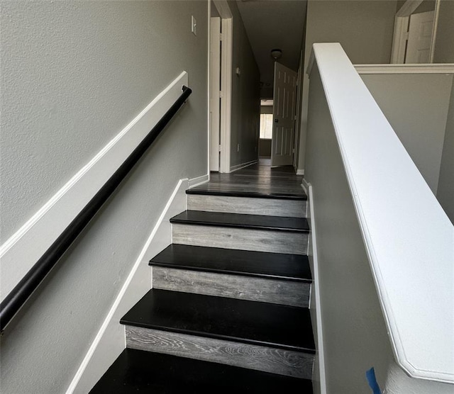 stairway featuring wood finished floors