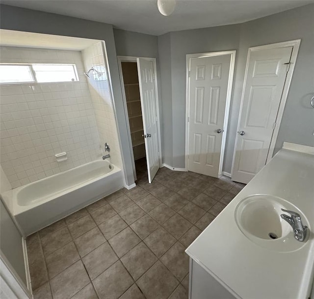 bathroom featuring washtub / shower combination, tile patterned flooring, vanity, and baseboards