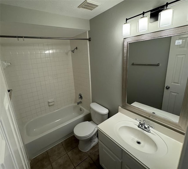 full bathroom featuring visible vents, toilet, tile patterned flooring, a textured ceiling, and vanity