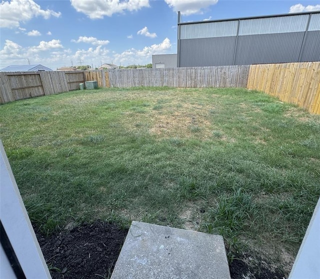 view of yard with a fenced backyard