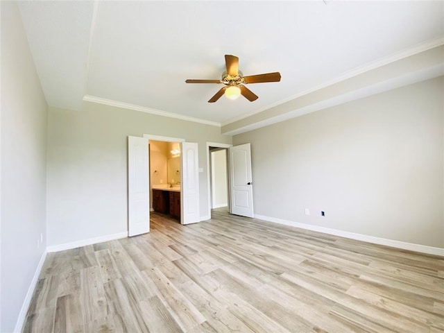 unfurnished bedroom with ensuite bathroom, light wood-style floors, and baseboards