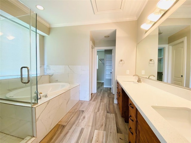 full bath featuring double vanity, a sink, a bath, and crown molding