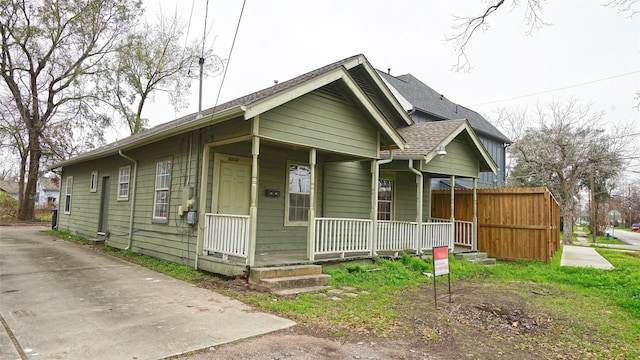 bungalow-style house featuring a shingled roof and a porch