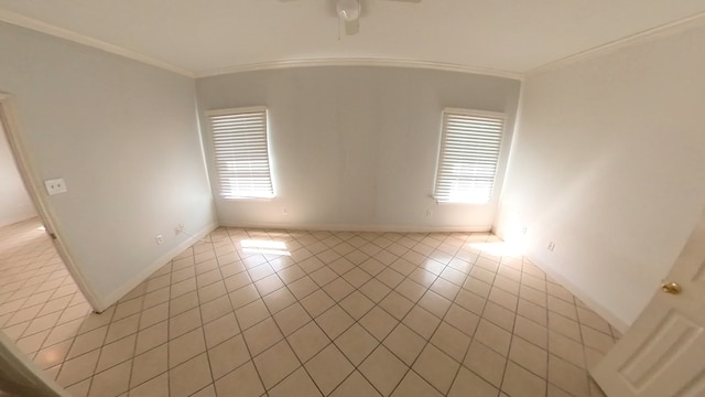 spare room with light tile patterned floors, ornamental molding, a ceiling fan, and a healthy amount of sunlight