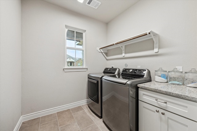 laundry room with cabinet space, baseboards, visible vents, washer and dryer, and light tile patterned flooring