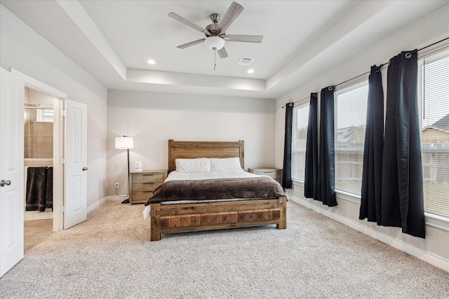 carpeted bedroom with baseboards, visible vents, a raised ceiling, and recessed lighting