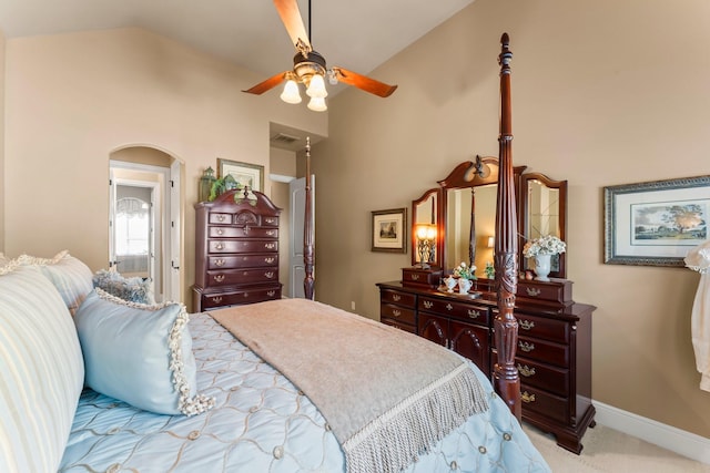 bedroom featuring high vaulted ceiling, arched walkways, carpet flooring, and baseboards