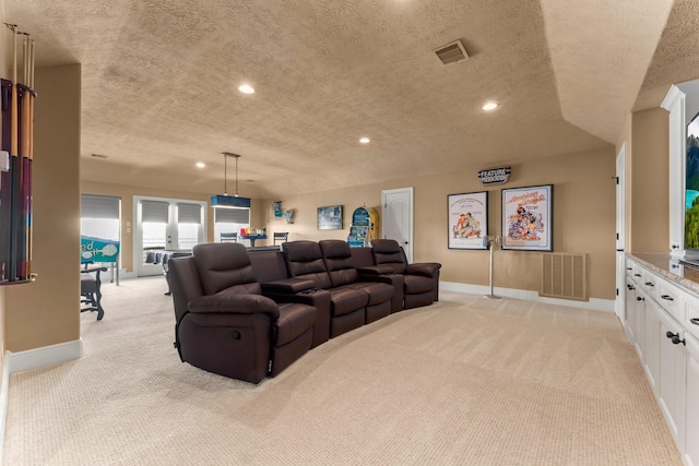 home theater room with light colored carpet, recessed lighting, and visible vents