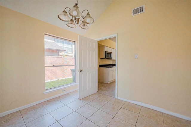 unfurnished dining area featuring a wealth of natural light, visible vents, an inviting chandelier, and light tile patterned floors