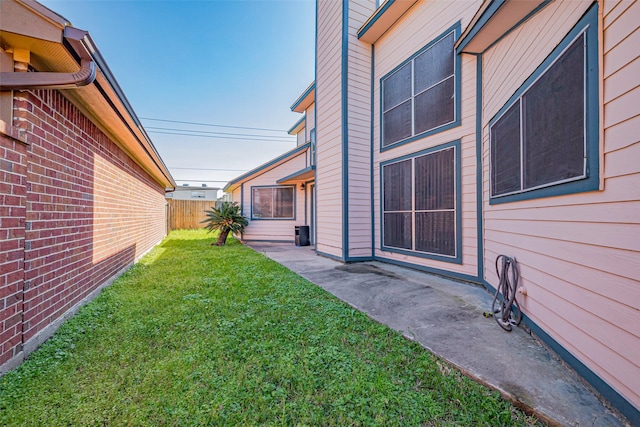 view of yard featuring a patio and fence