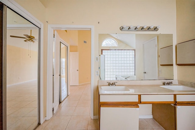 full bathroom featuring tile patterned flooring, double vanity, ceiling fan, and a sink