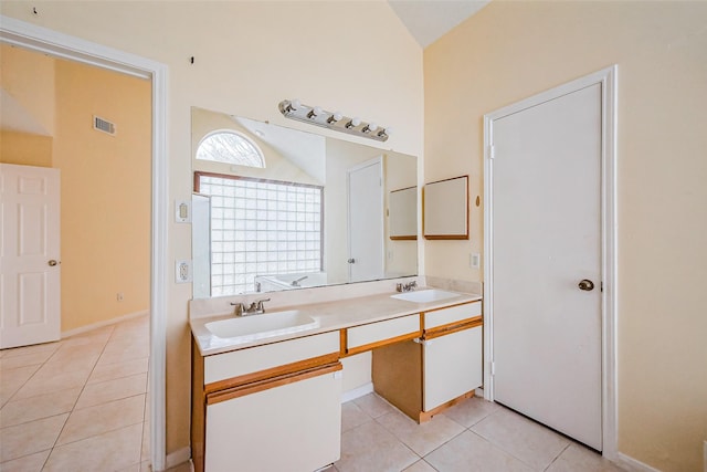 full bathroom featuring tile patterned floors, double vanity, visible vents, and a sink