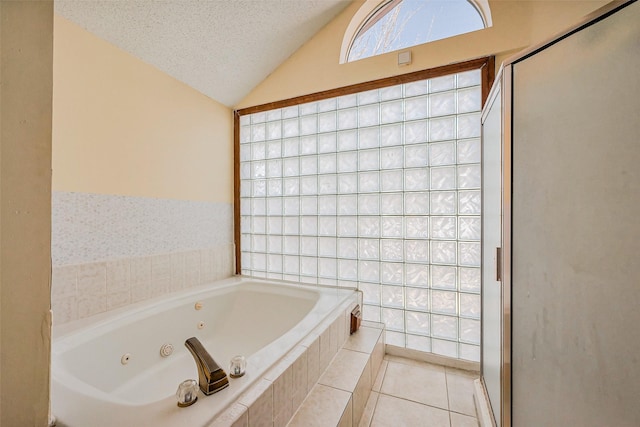 bathroom with tile patterned floors, a textured ceiling, a shower stall, lofted ceiling, and a whirlpool tub