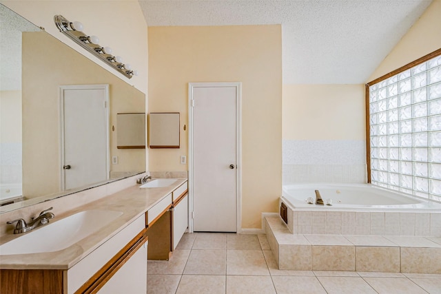 bathroom with tile patterned flooring, a textured ceiling, and a sink