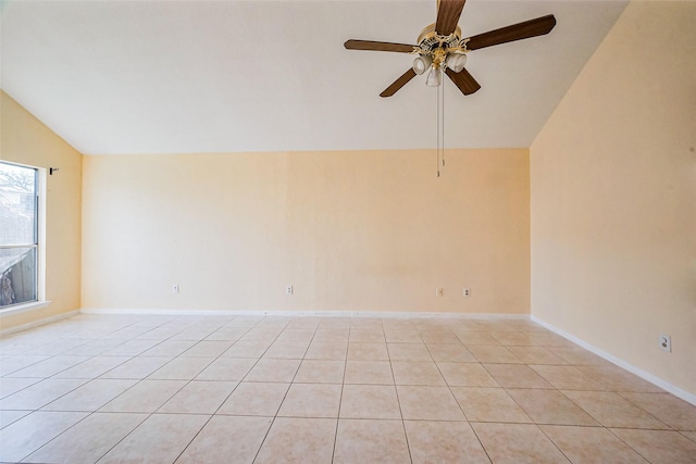 empty room featuring light tile patterned floors, baseboards, a ceiling fan, and vaulted ceiling