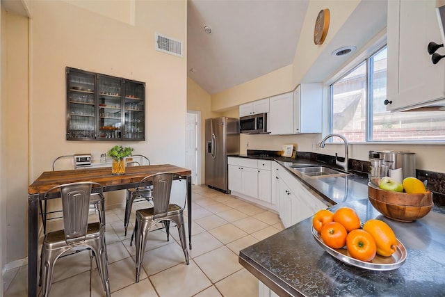 kitchen featuring a sink, dark countertops, visible vents, and stainless steel appliances