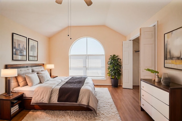 bedroom featuring wood finished floors, a ceiling fan, and vaulted ceiling