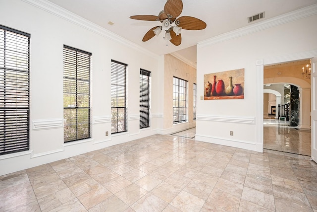 unfurnished room with visible vents, arched walkways, baseboards, ceiling fan, and ornamental molding