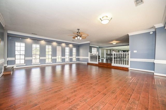 unfurnished living room featuring ornamental molding, hardwood / wood-style flooring, visible vents, and baseboards