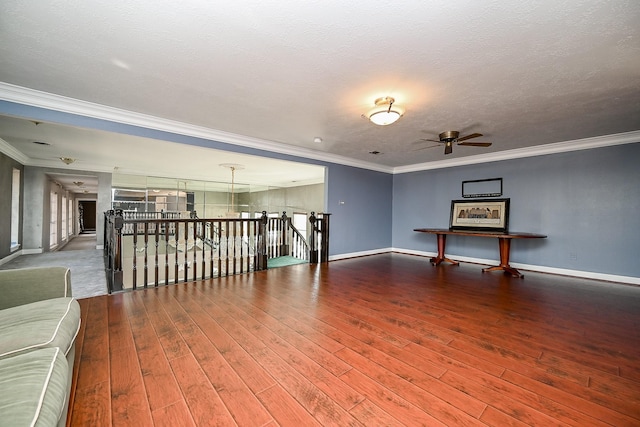 unfurnished room featuring ornamental molding, hardwood / wood-style flooring, and baseboards